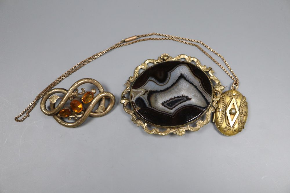 Two Victorian gilt metal brooches, a similar locket pendant on chain and a ladys silver cased wrist watch.